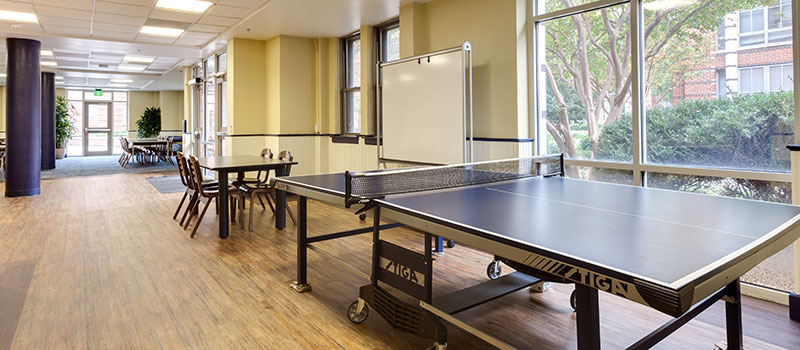Recreation area with table tennis, table and chairs.