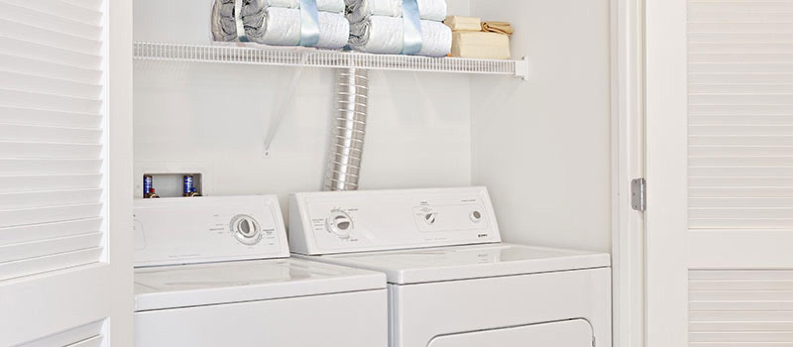 Laundry closet with washer and dryer.