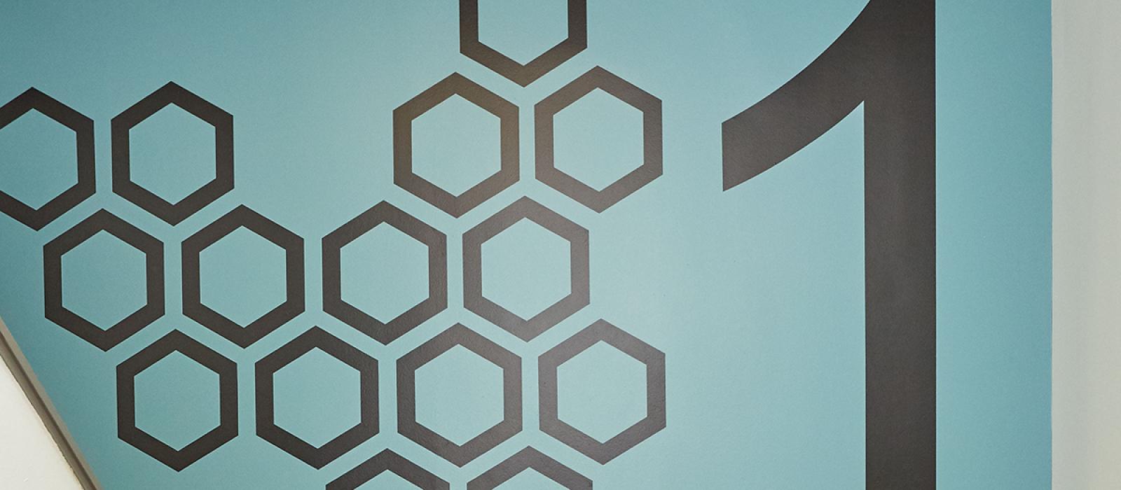 Detail of the stairwell with an hexagon design and a 1.