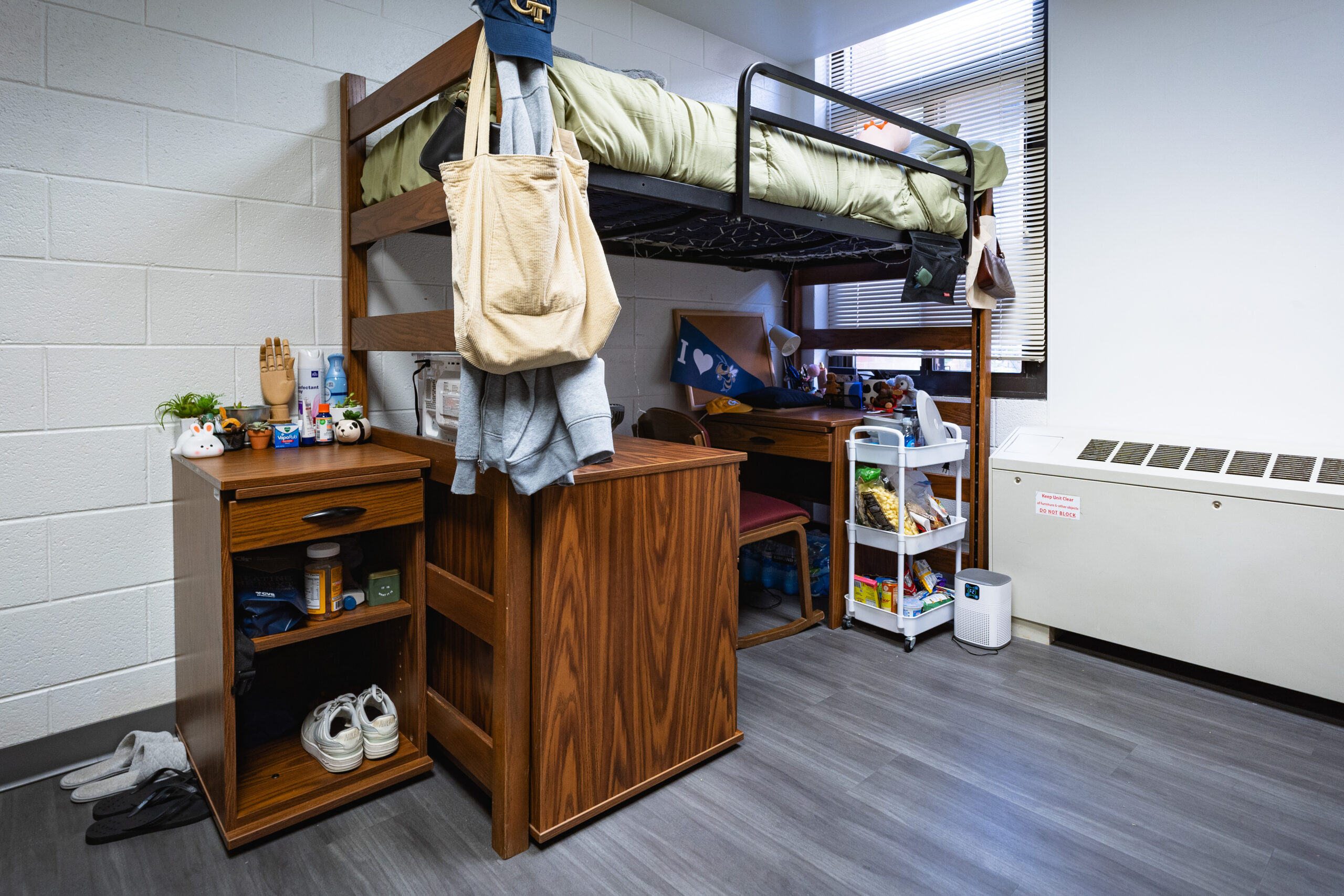 Lofted bed with dresser, desk, and chair underneath